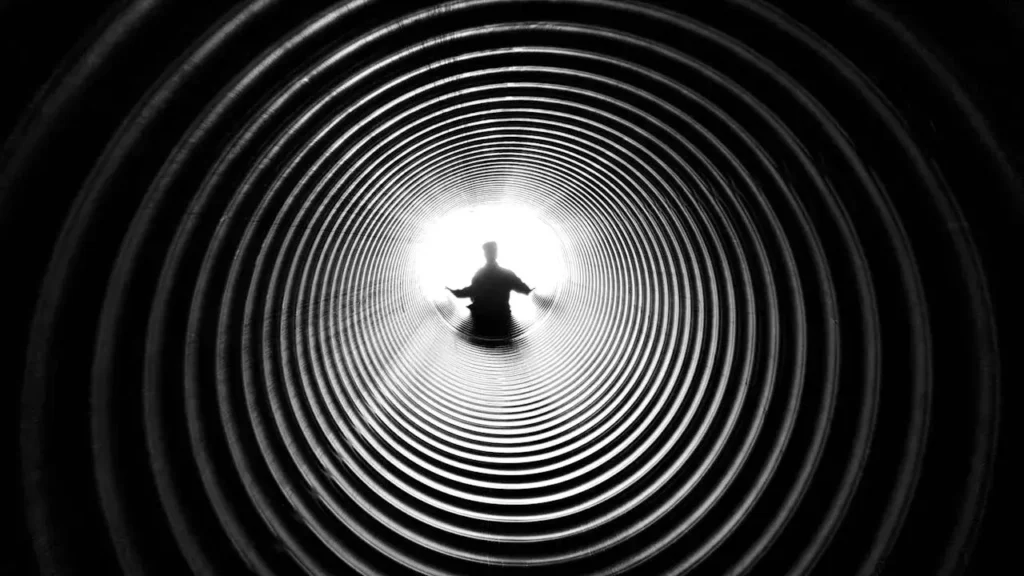 A silhouette seen at the end of a tunnel